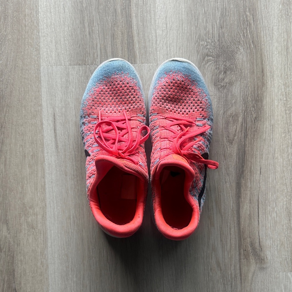 Woman’s Vibrant Orange and Blue Nike Sneakers